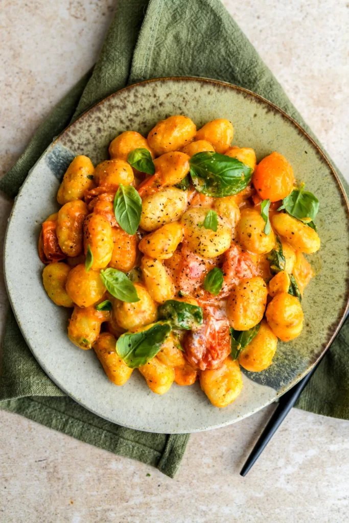 tomato gnocchi on ceramic plate